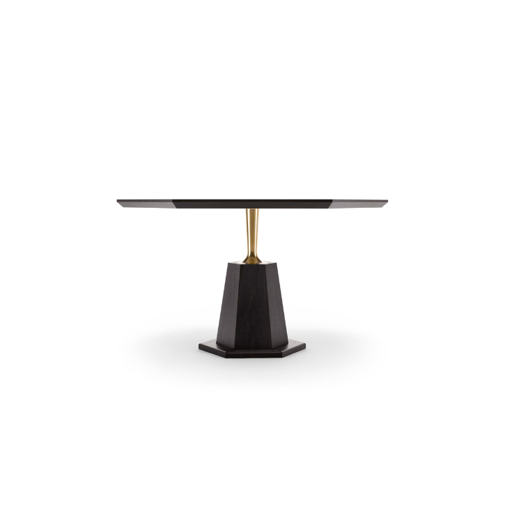 A modern dining table with a black base and a gold support column, with a black rectangular tabletop.