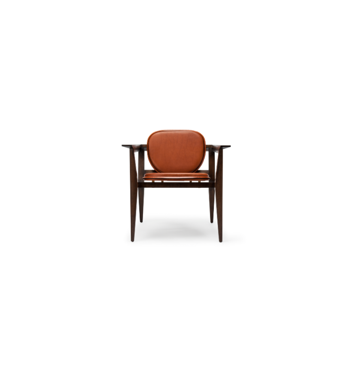 A vintage wooden armchair with orange leather cushions on a white background.