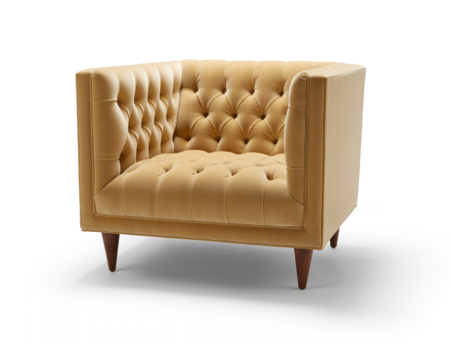 A beige tufted armchair with wooden legs on a white background.