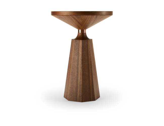 Wooden side table with a round top and a tapered, angular base.