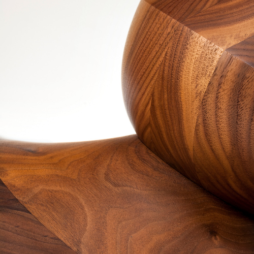 Close-up of a polished wooden sculpture with smooth curves and a rich wood grain.