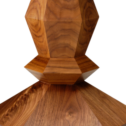 Close-up of a wooden hexagonal container or decorative object placed on a wooden surface.