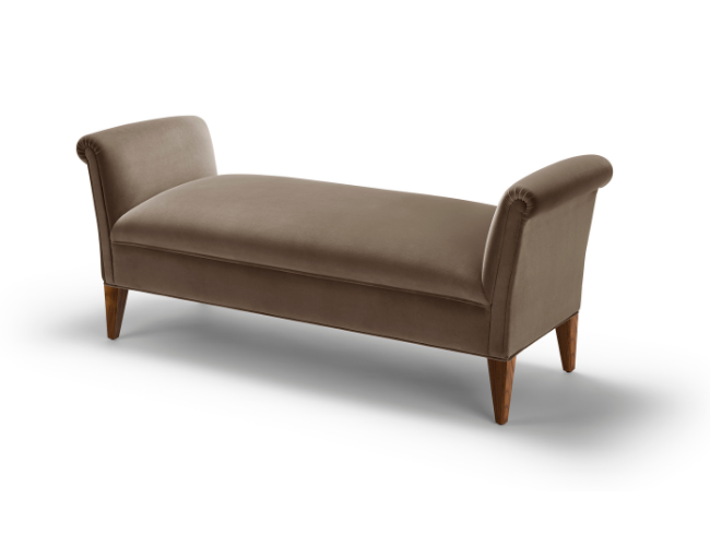 A beige upholstered chaise lounge with wooden legs against a white background.