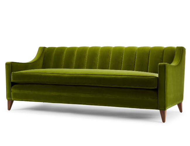 Green velvet mid-century modern sofa with wooden legs.