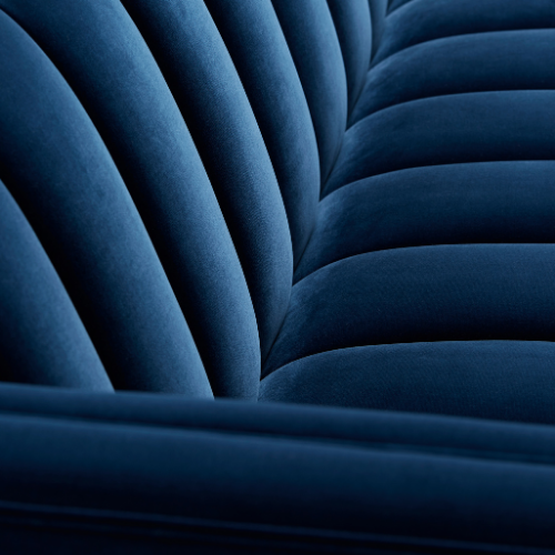 Close-up of a blue upholstered fabric with seam detailing.
