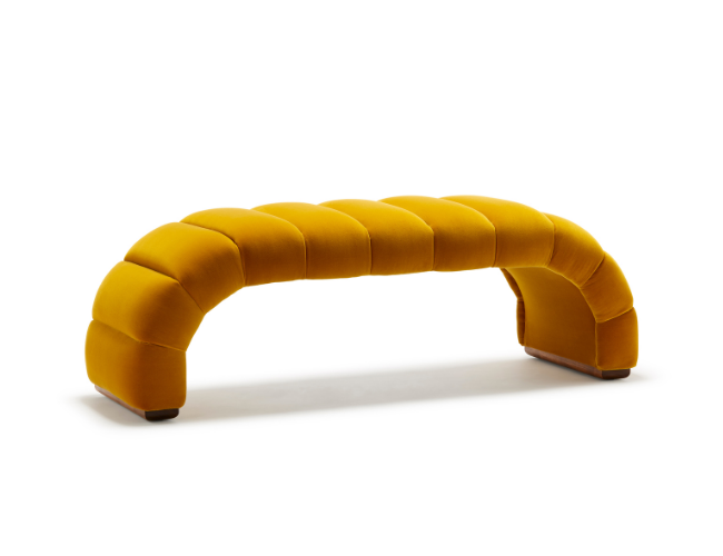 A modern, yellow-orange upholstered bench with a curved, segmented design on a white background.