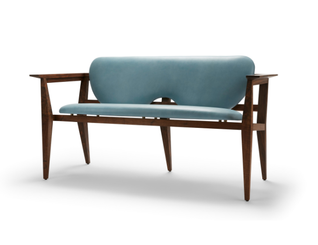 A mid-century modern wooden bench with light blue cushion and backrest, isolated on white background.