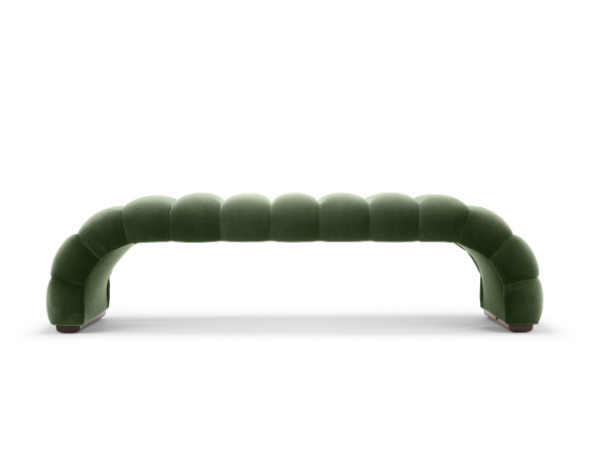 Modern green velvet couch with curved, segmented design on a white background.