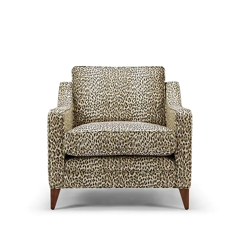 Leopard print armchair with wooden legs on a white background.