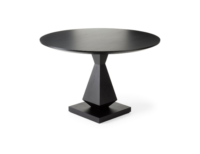 Black round dining table with a geometric base on a white background.