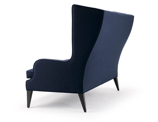 A modern navy blue upholstered armchair with angled wooden legs.
