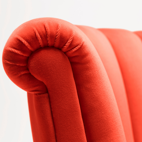 Isabella Occasional Chair shown here with black legs and upholstered in Dedar Piment cotton velvet. View of the scroll detail
