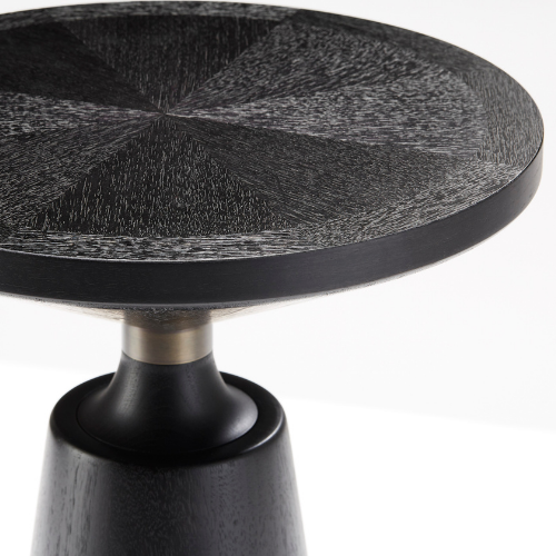 Close-up of a black wooden side table with a round top and a single black pedestal base.