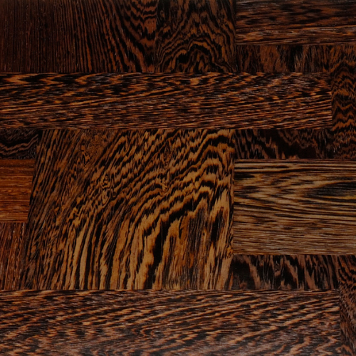Close-up of wooden parquet flooring with dark and light streaks.