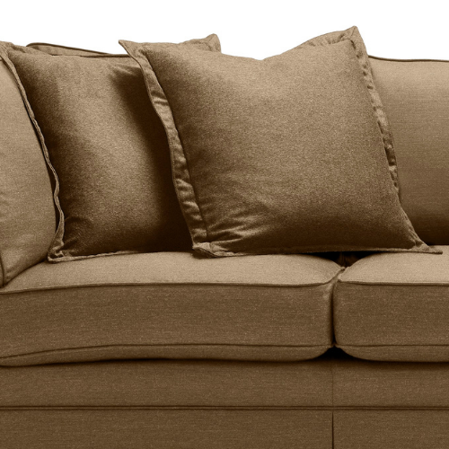 Close-up of a beige sofa with four beige pillows.