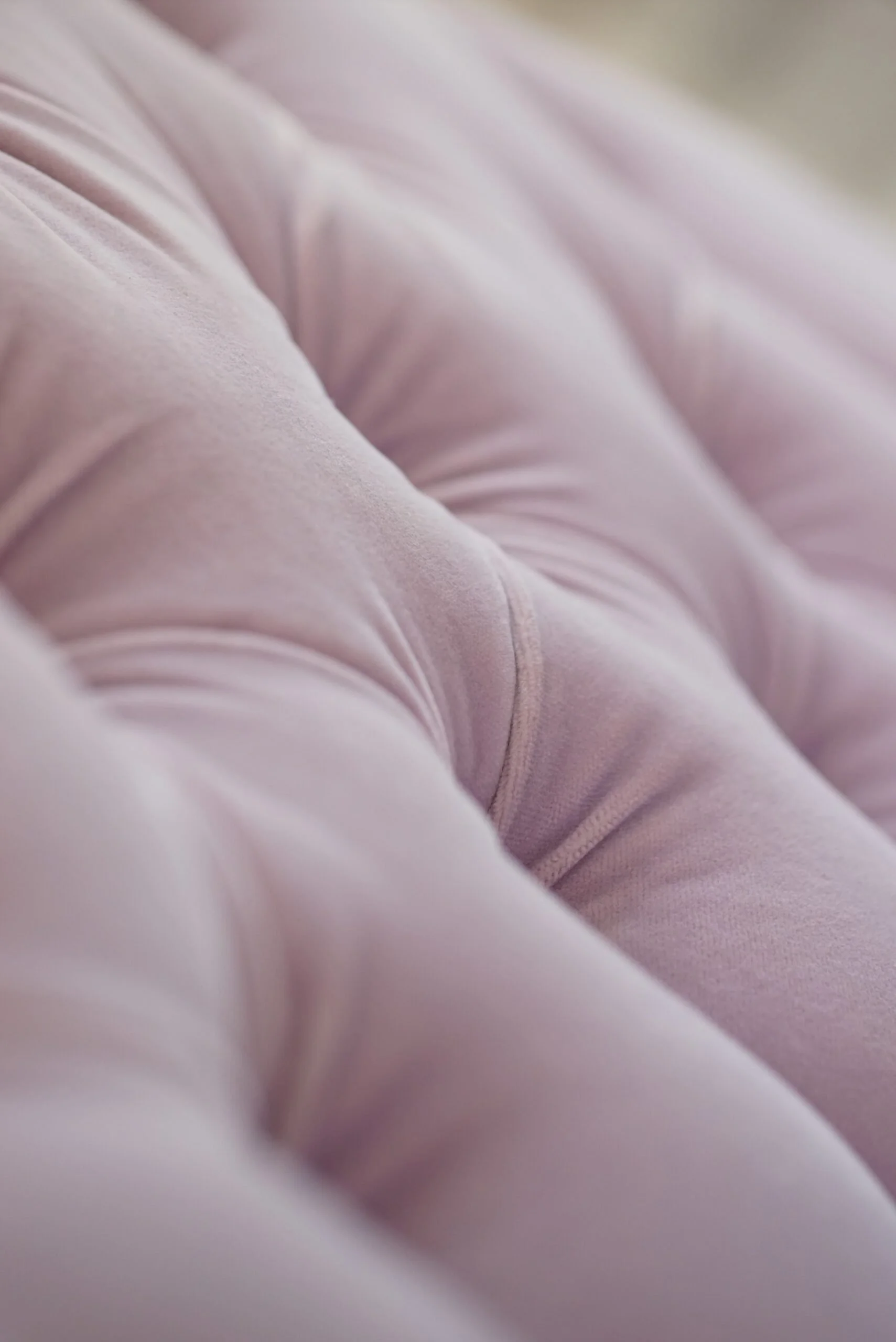 Close-up of pink fabric with soft folds and texture.