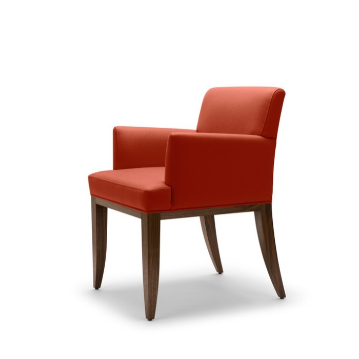 Red upholstered armchair with wooden legs on a white background