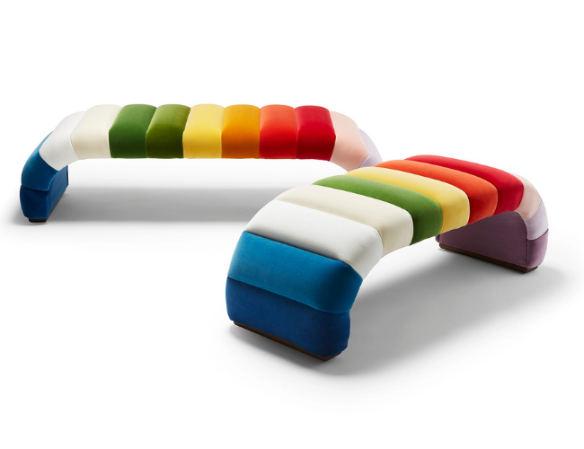 Rainbow-colored arch-shaped sofa with a segmented design, displaying colors from blue, white, green, yellow, orange, red, and purple.