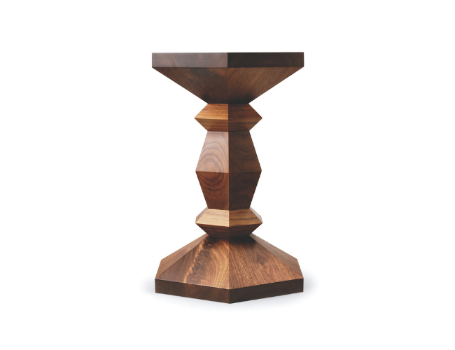Wooden side table with geometric shapes and a hexagonal base.