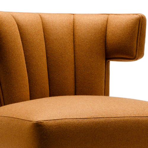 Close-up of an orange upholstered chair with vertical stitching and a rounded armrest.
