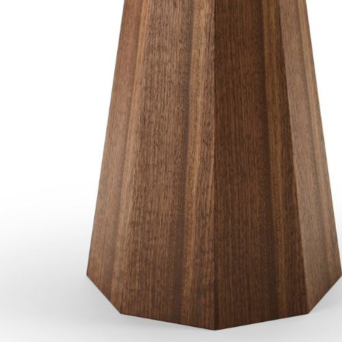 Close-up of a wooden table with a tapered, polygonal base.