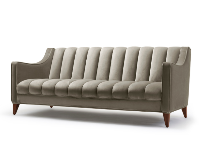 A beige mid-century modern sofa with tufted upholstery and wooden tapered legs.