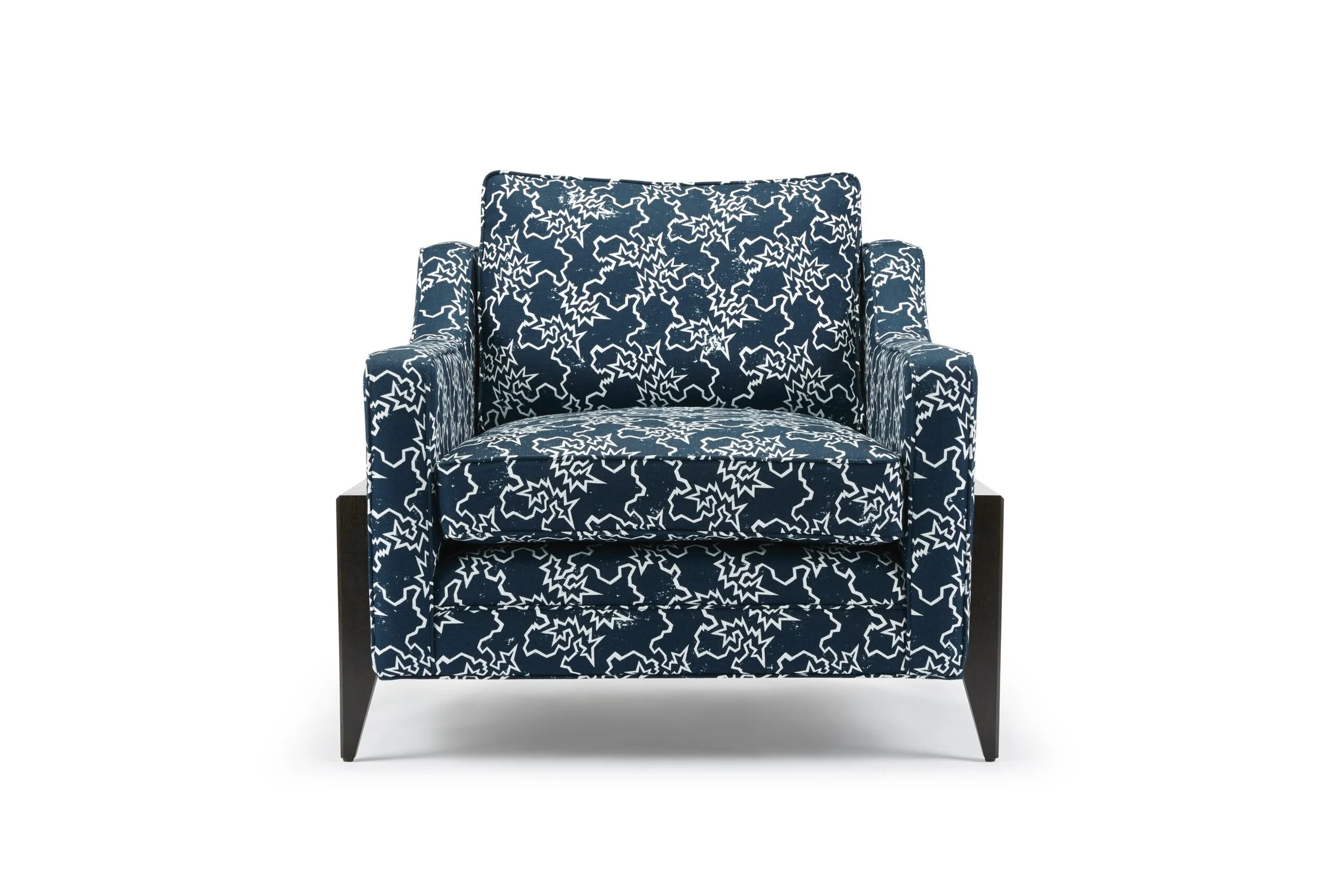 A dark blue Reposer armchair with a white abstract star pattern, wooden legs, and a high back.