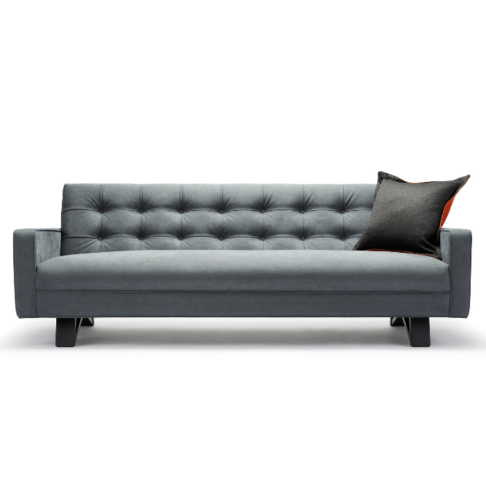 Gray upholstered sofa with button-tufted backrest and a black pillow, set against a white background.