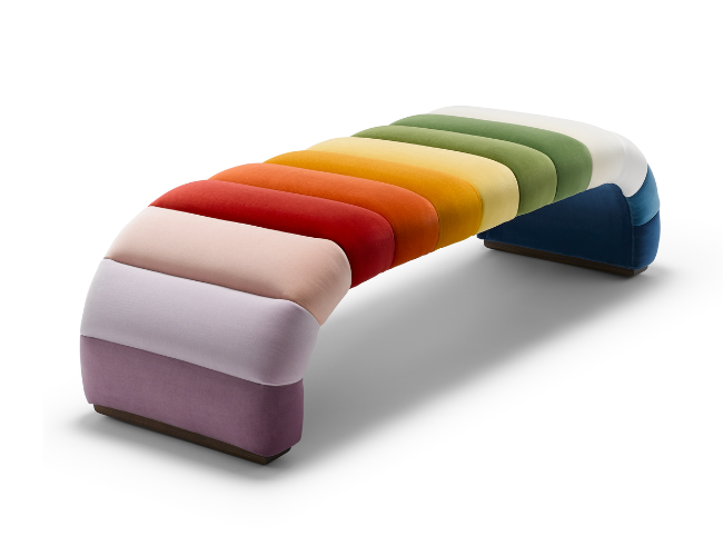 Colorful rainbow-shaped upholstered bench with gradient colors from purple to white, green, yellow, orange, red, and blue.