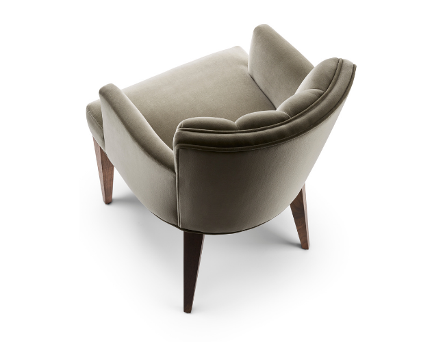 A green upholstered armchair with wooden legs, viewed from the back, on a white background.