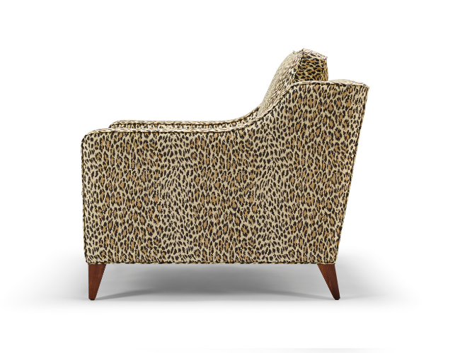 Leopard print upholstered armchair with wooden legs