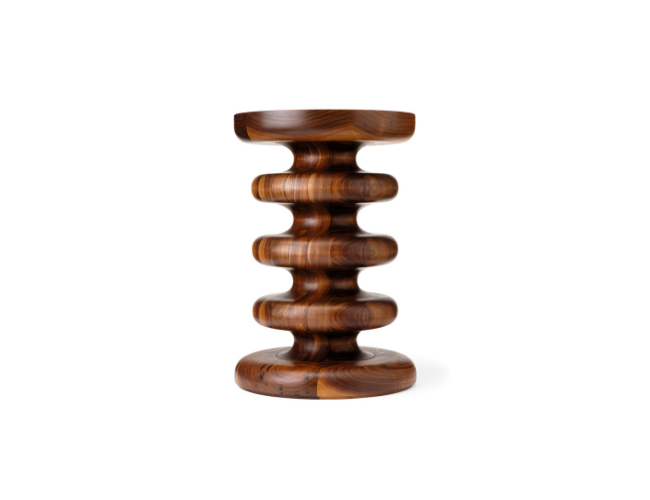 Wooden decorative sculpture with a sculptural, stacked, wavy design on a white background.