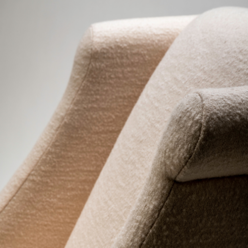 Close-up of three upholstered chairs in beige, light brown, and dark brown colors.