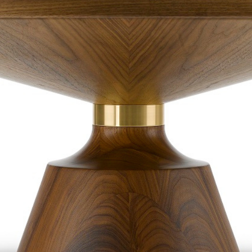 Close-up of a wooden table with a gold-colored accent at the base.