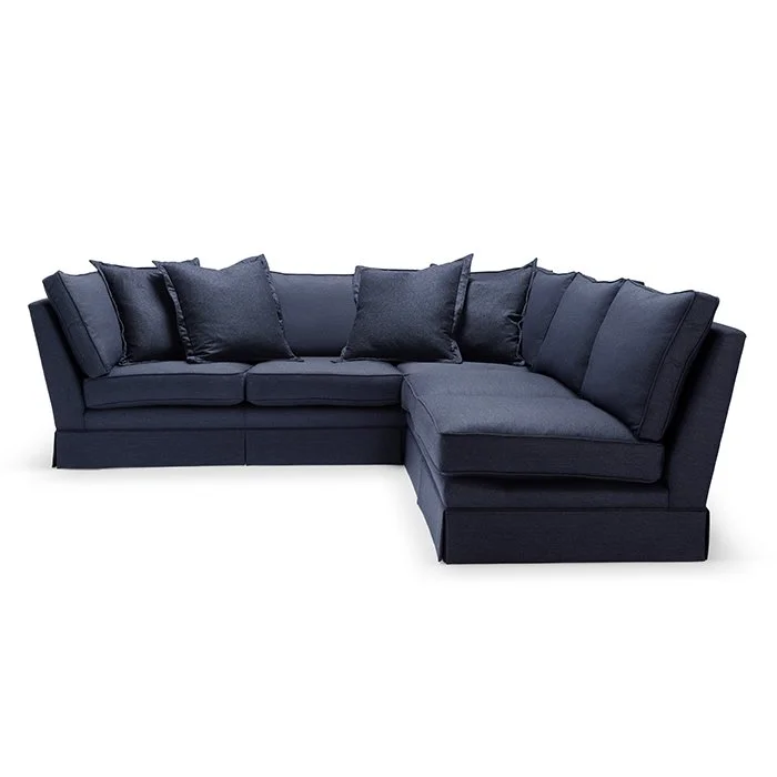 A navy blue sectional sofa with matching pillows on a white background.