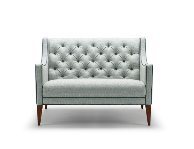 Light gray upholstered loveseat with button tufting and wooden legs.