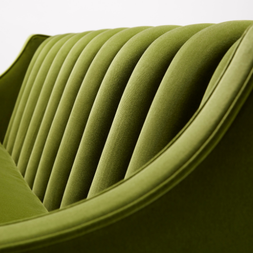 Close-up of a modern green upholstered chair with vertical channel tufting.