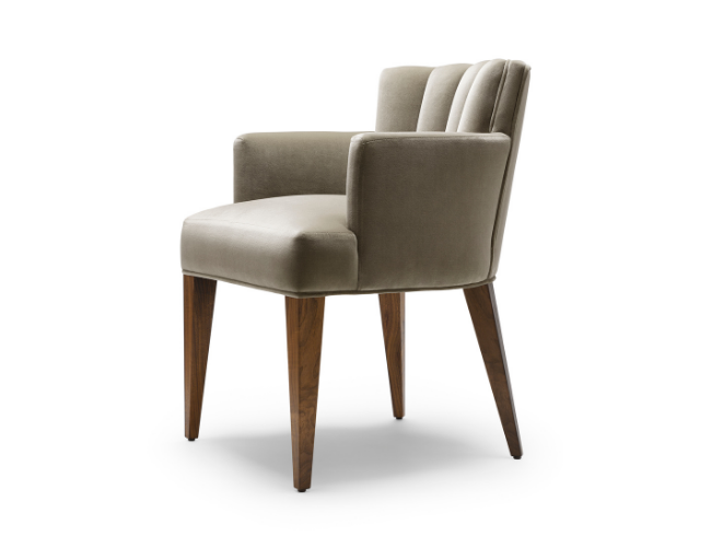 Modern upholstered armchair with wooden legs and a light beige fabric, viewed from the side.