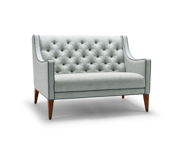 Light gray upholstered loveseat with button-tufted backrest and wooden legs.