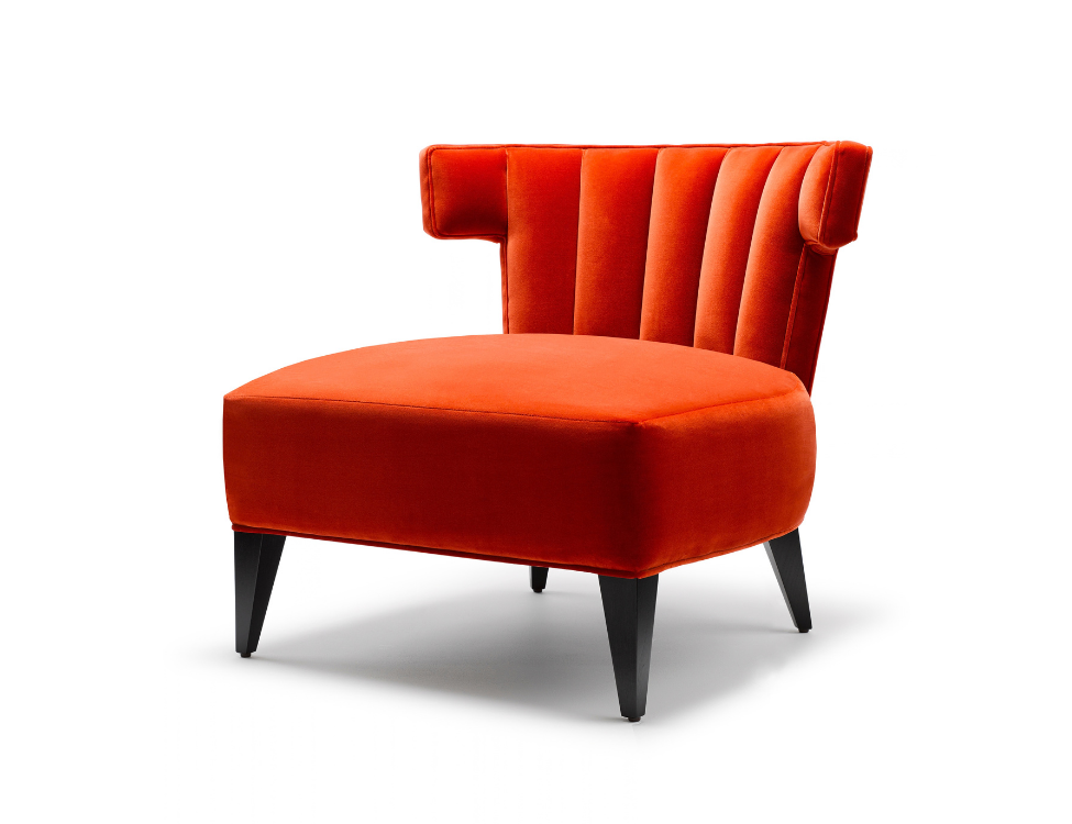 Orange velvet modern accent chair with black wooden legs.