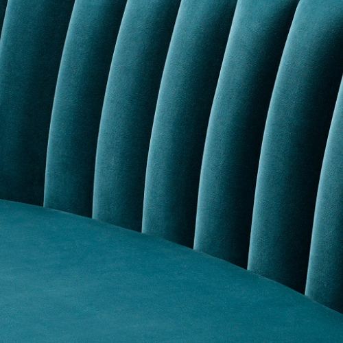 Close-up of a teal upholstered chair with vertical backrest panels.