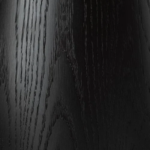 Close-up of black wooden surface with visible wood grain.