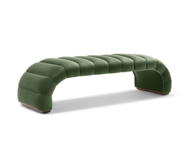 Green upholstered curved bench with tufted cushions on a white background.