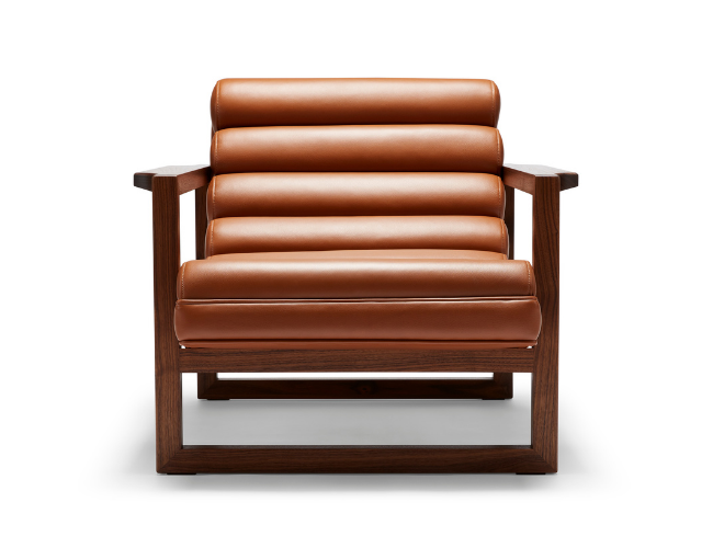 The Florence Easy Chair is a bare-wood constructed chair with a fluted leather seat in a light tan.