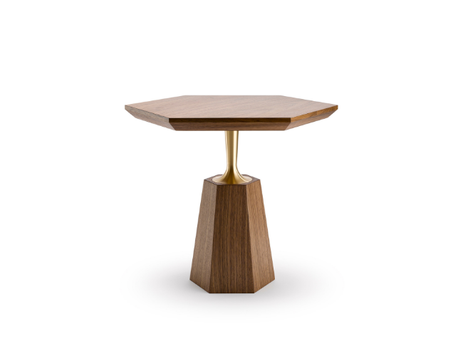 A modern hexagonal wooden side table with a gold-colored metal support and a tapered wooden base