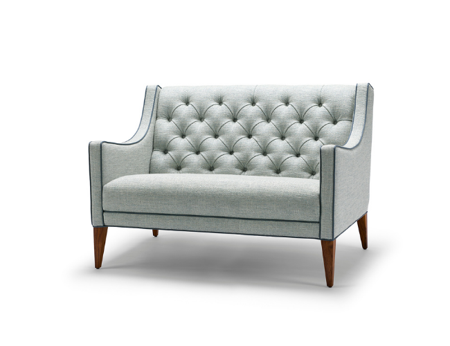 Light gray upholstered loveseat with tufted backrest and wooden tapered legs.