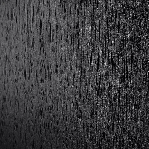 Close-up of a dark wooden surface with visible wood grain texture.