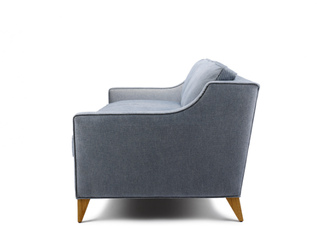 Side view of a light blue upholstered sofa with wooden legs against a white background.