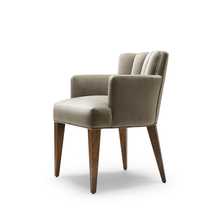 A beige upholstered armchair with wooden legs on a white background.