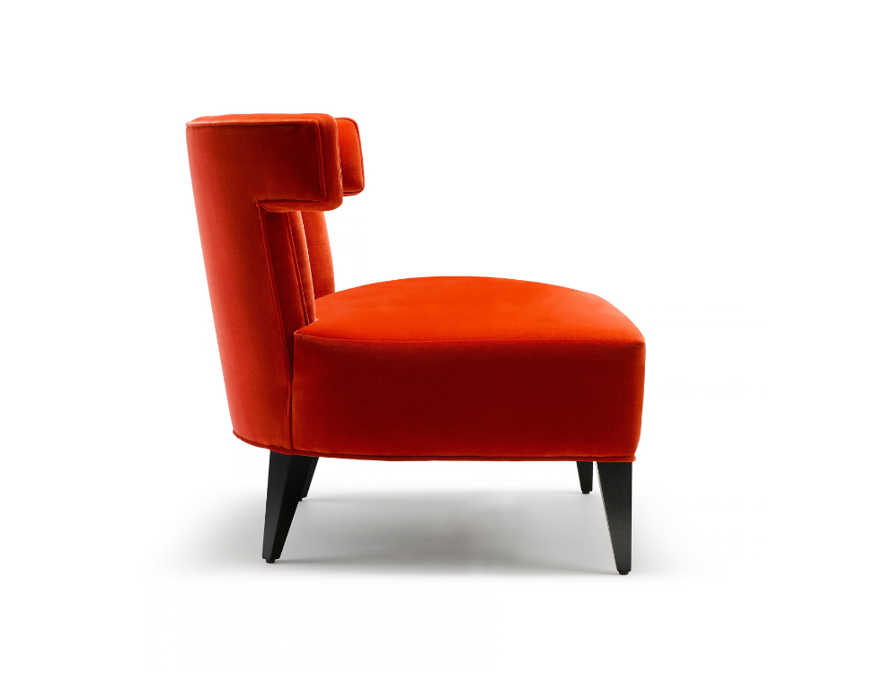 Red velvet accent chair with black wooden legs isolated on white background.